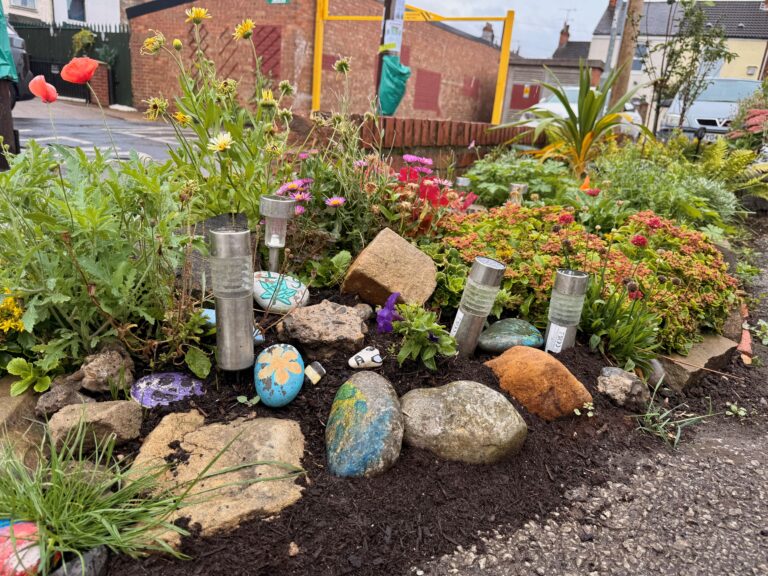 The rockery garden with hand-painted stones contributed by local children.